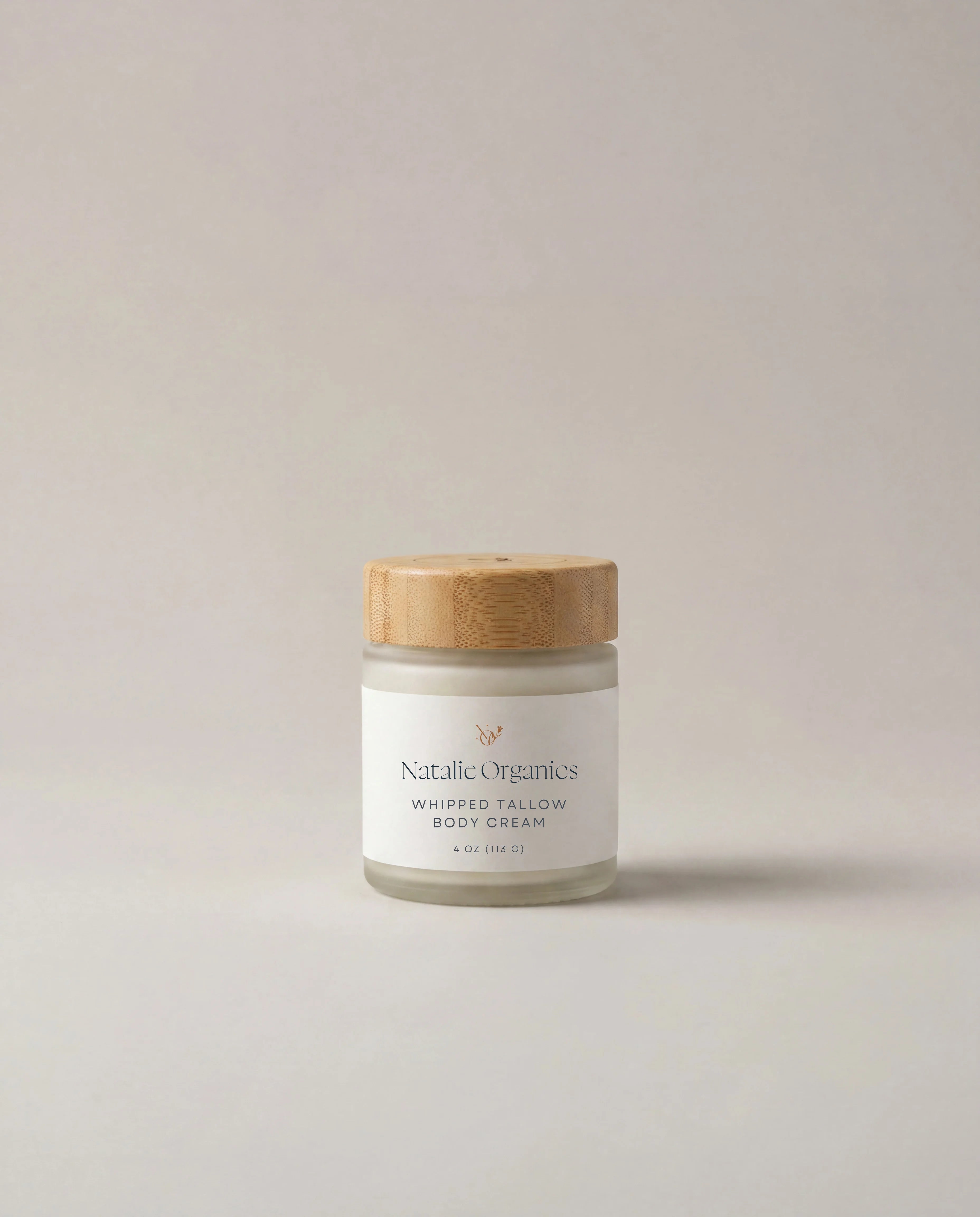 Whipped tallow body cream jar with wooden lid, white label