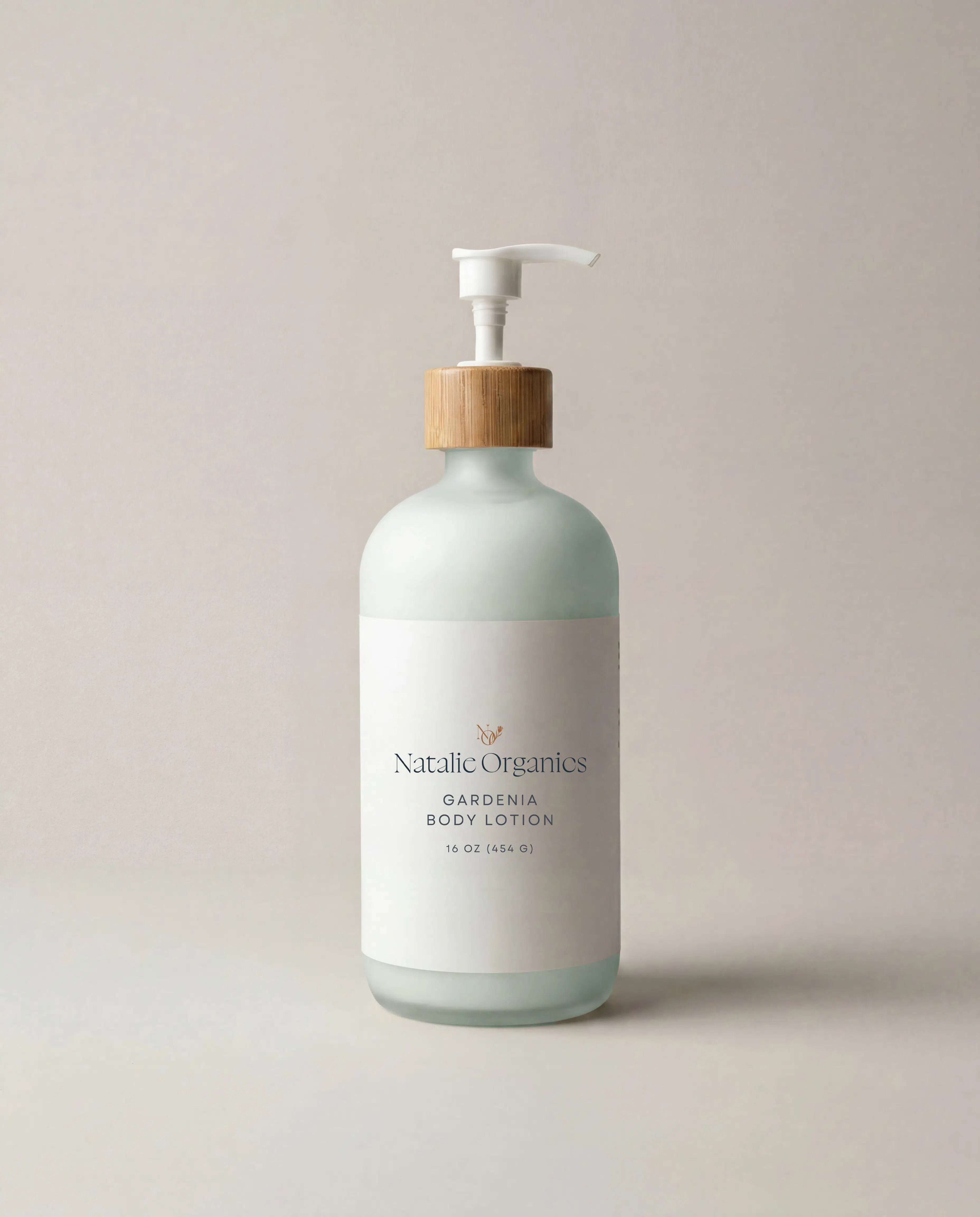 Body lotion bottle with pump, white label and pale green glass