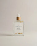 Glass jasmine body oil bottle with amber dropper and white cap