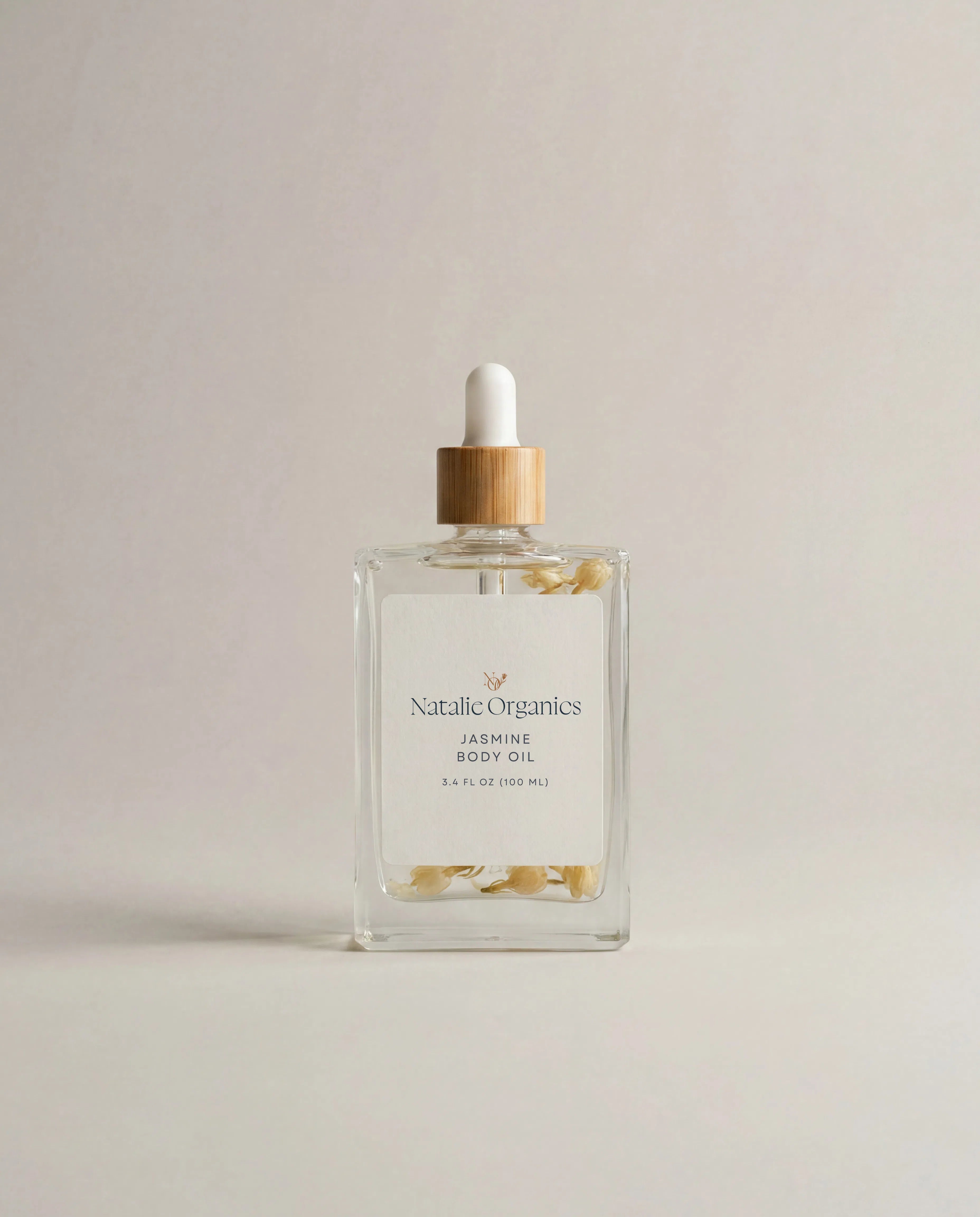 Glass jasmine body oil bottle with amber dropper and white cap