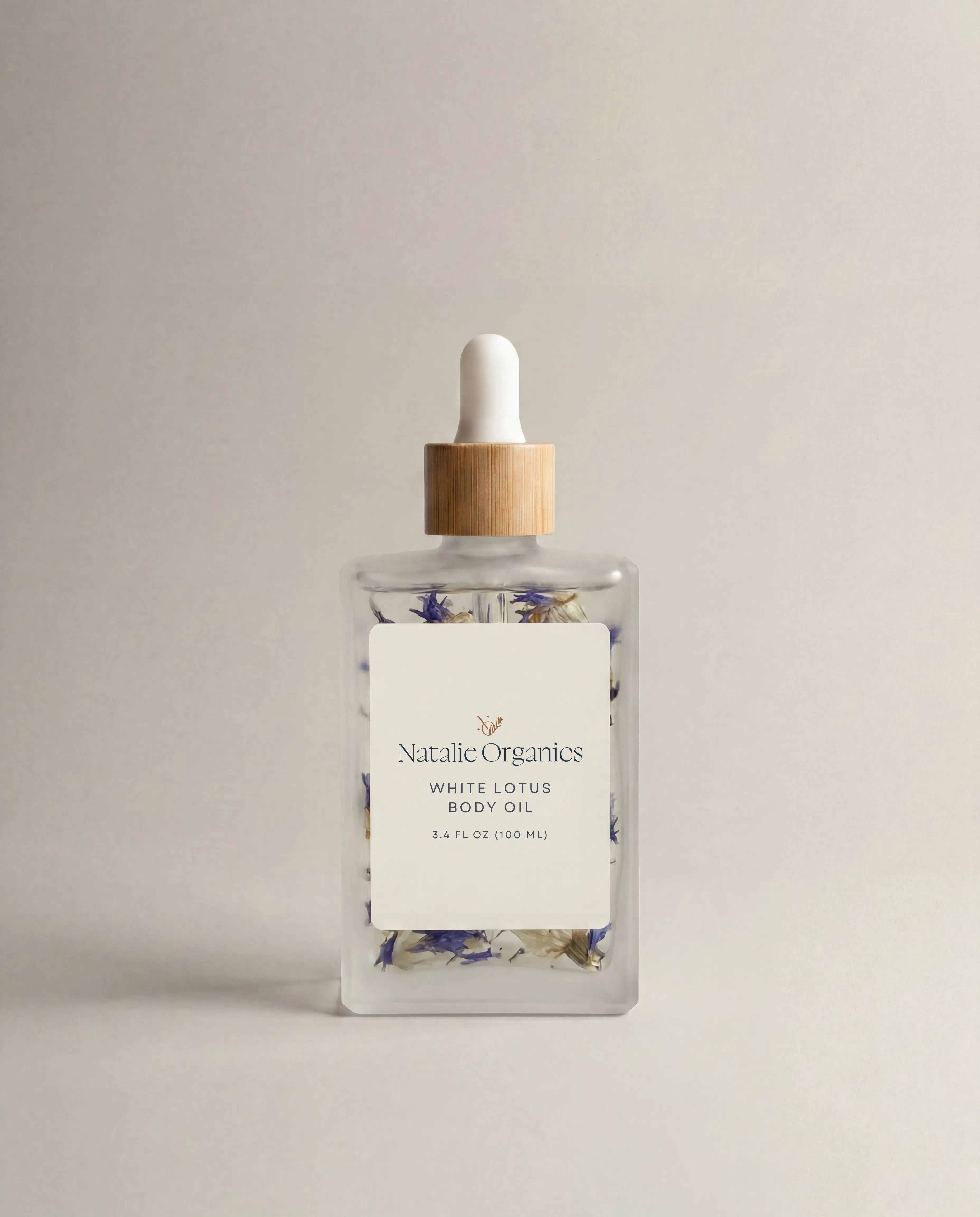 White Lotus body oil bottle with clear glass, dropper pump, and floral label