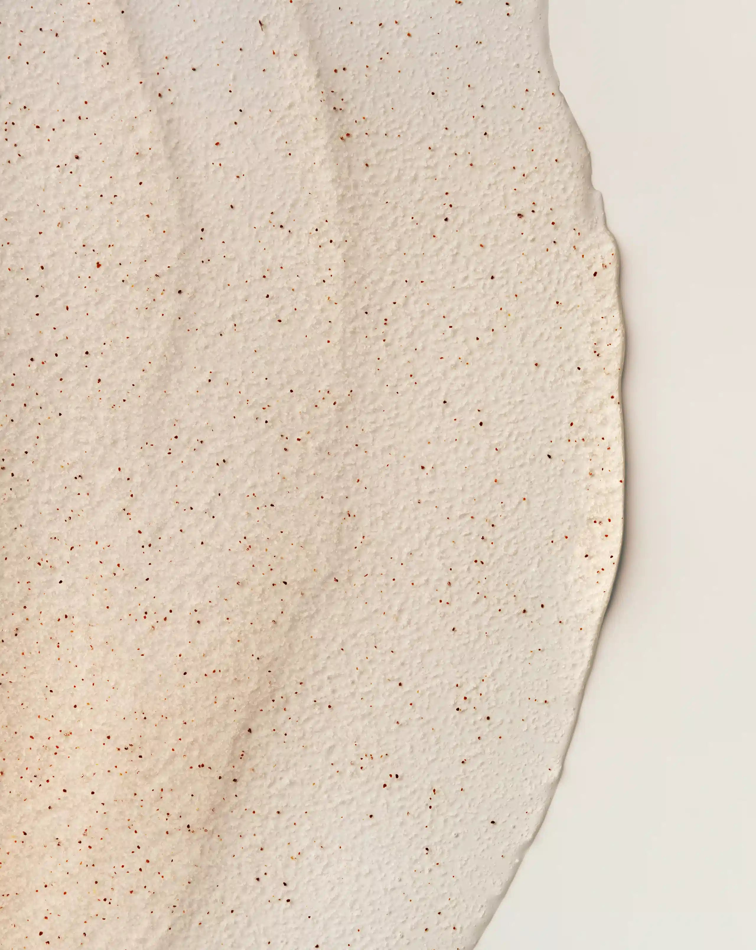 Granular body scrub texture with small specks on surface