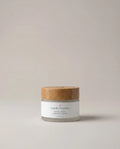 Firming cream jar with white label and wood-toned lid
