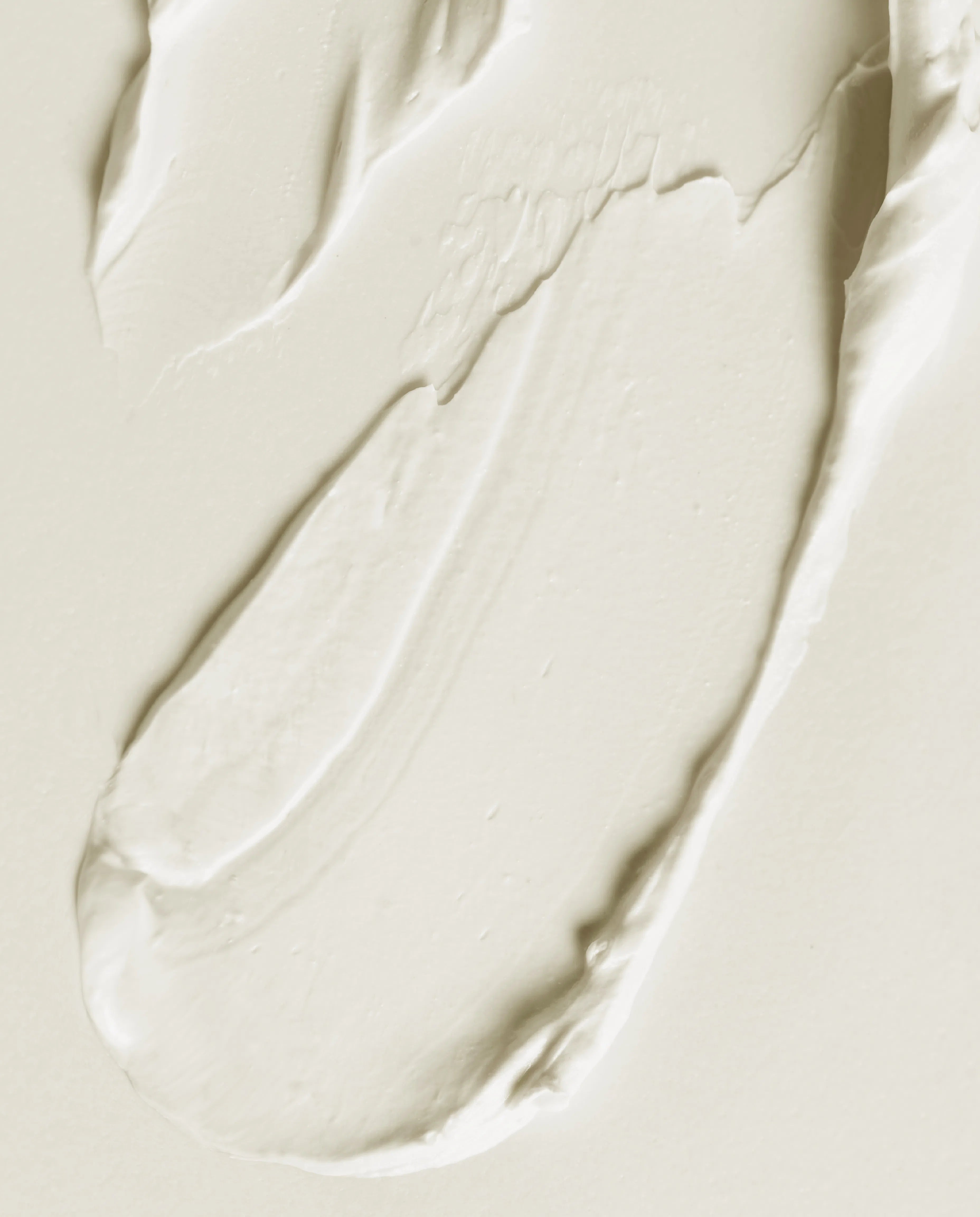 Soothing mask cream swatch on light surface, smooth thick texture