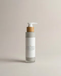 Facial cleanser bottle with pump, cream label and wooden collar