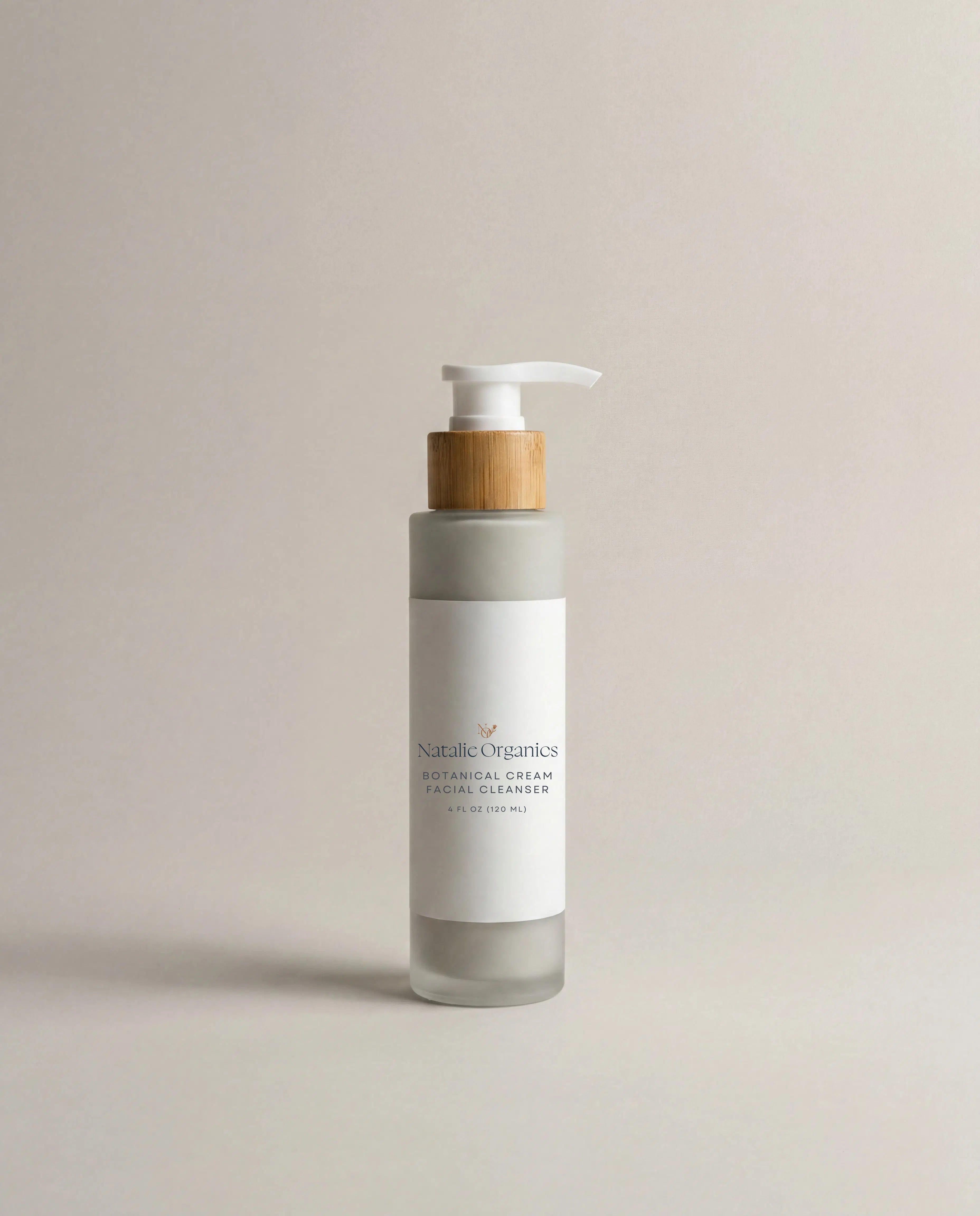 Facial cleanser bottle with pump, cream label and wooden collar