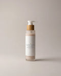 Rose-cream facial cleanser bottle with pump; frosted container and beige label