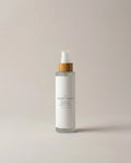 Facial toner bottle with pump, amber collar, white bottle and label