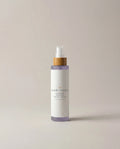 Facial toner bottle with pump, lavender band and label, in clear glass