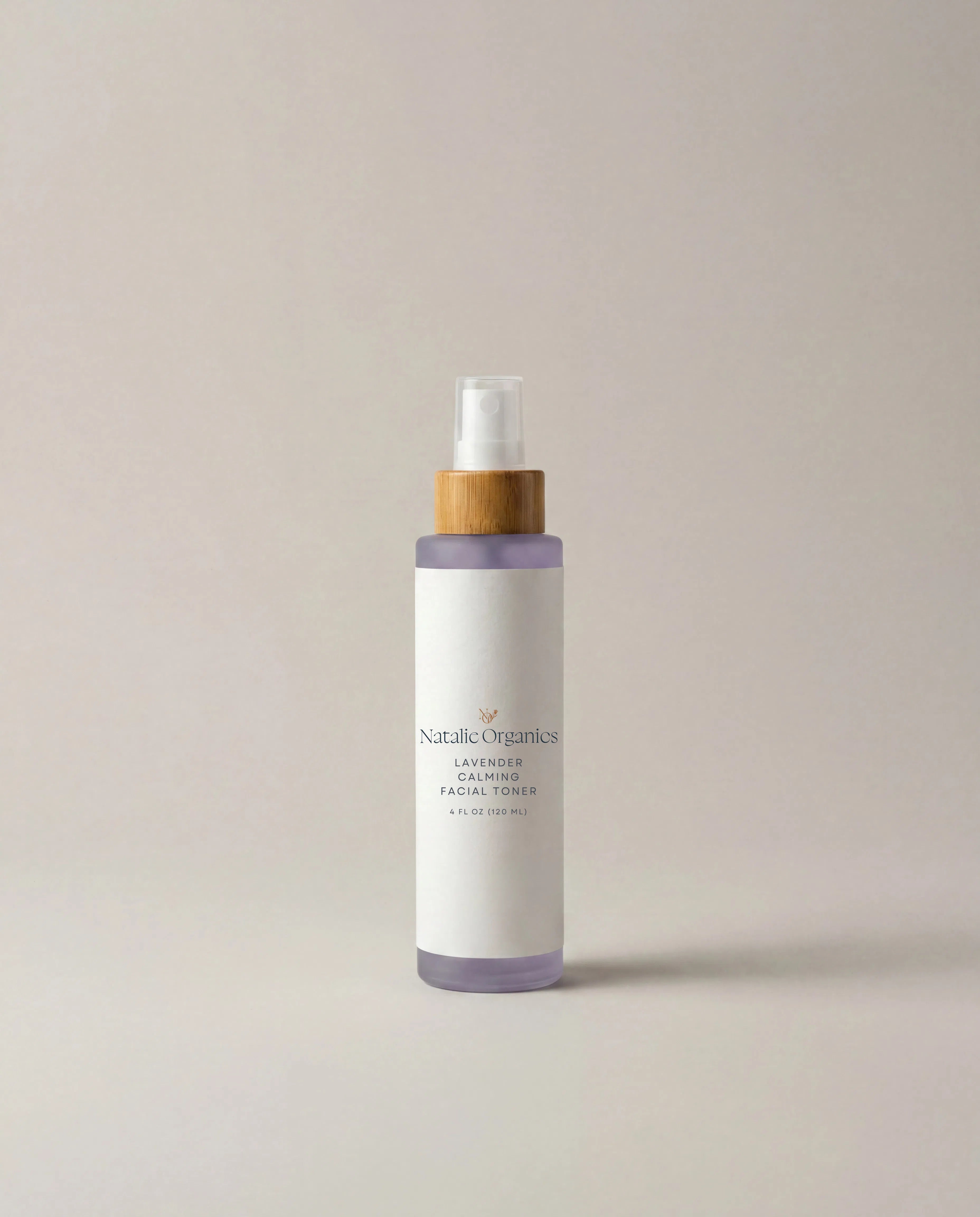 Facial toner bottle with pump, lavender band and label, in clear glass