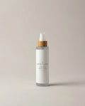 Facial toner bottle with white frosted body, gold collar, and clear pump