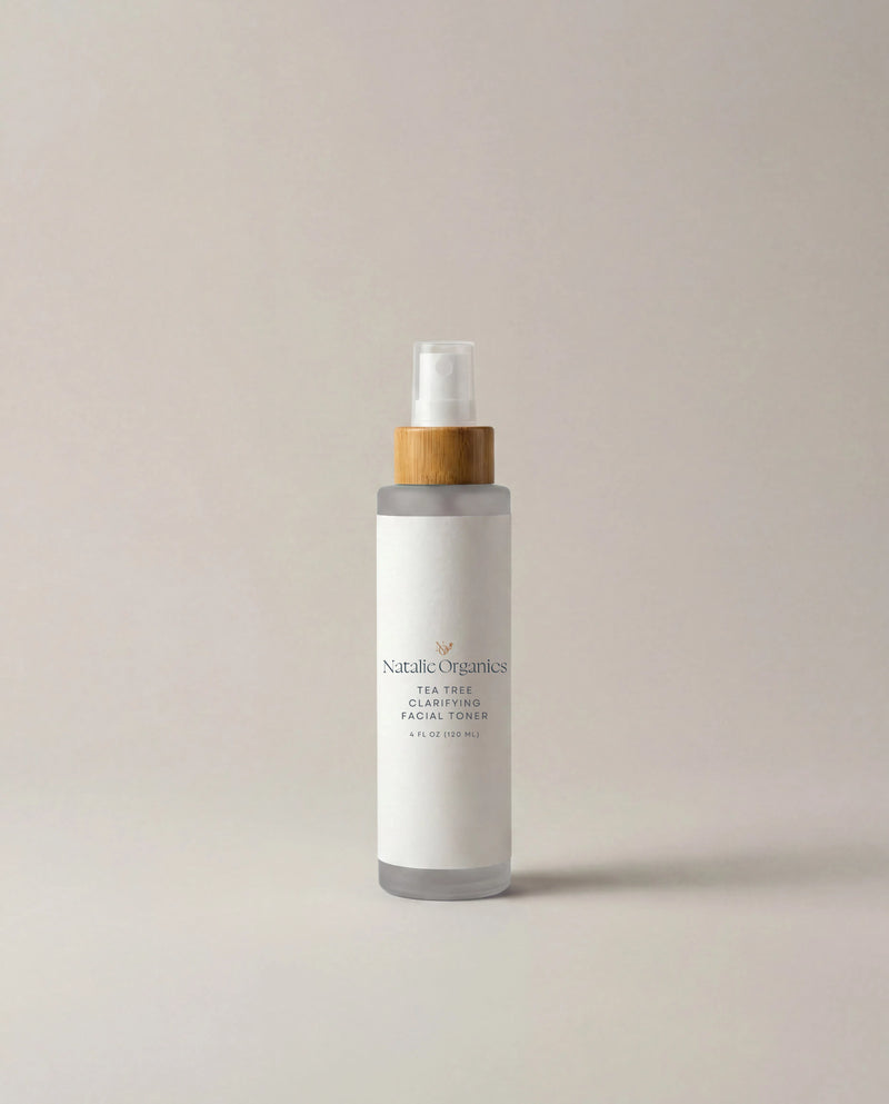 Facial toner bottle with white frosted body, gold collar, and clear pump