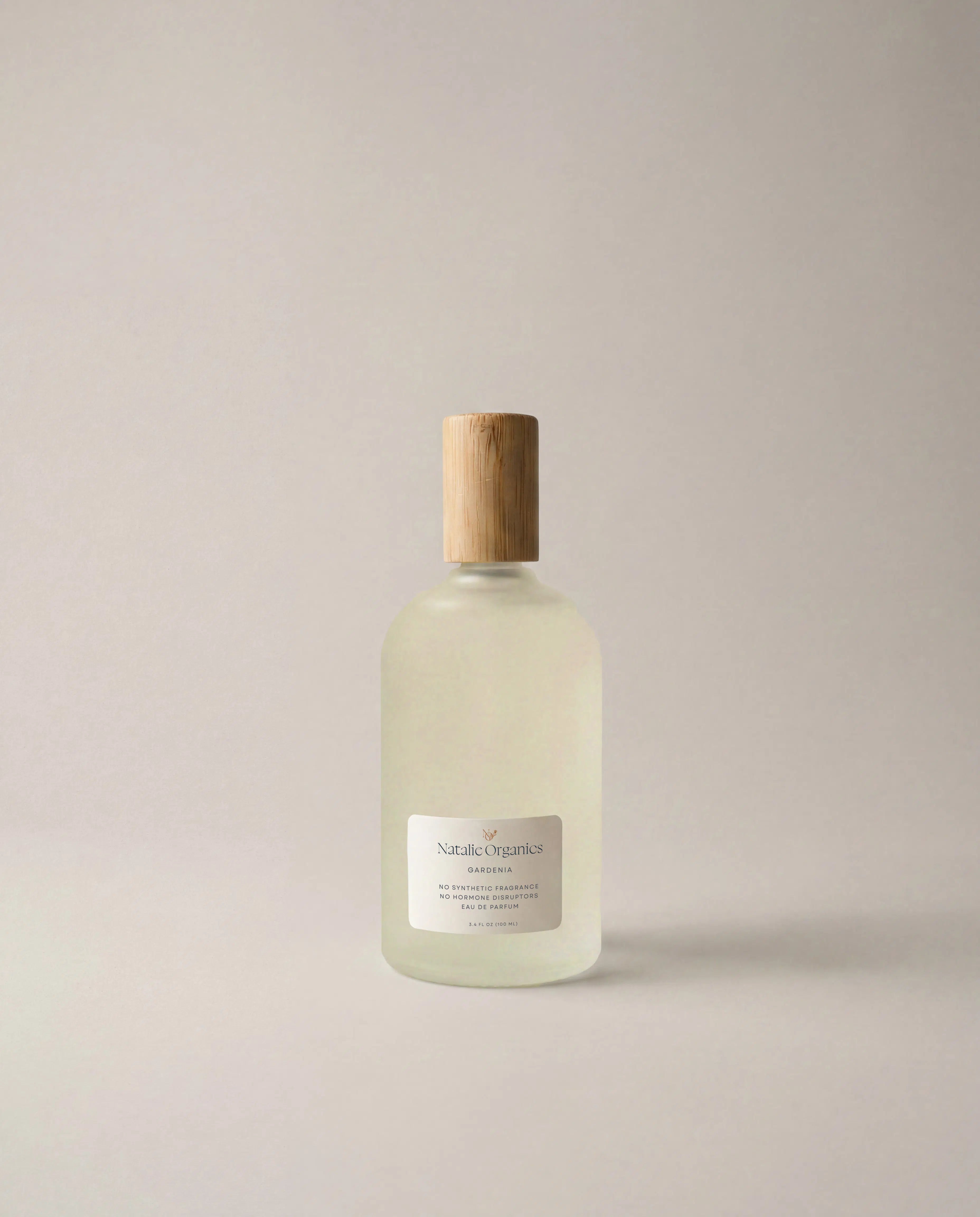 Fragrance bottle with wooden cap and white frosted liquid