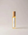 Yellow fragrance bottle with gold cap and rectangular label panel
