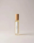 Small fragrance bottle with light amber liquid and wooden cap