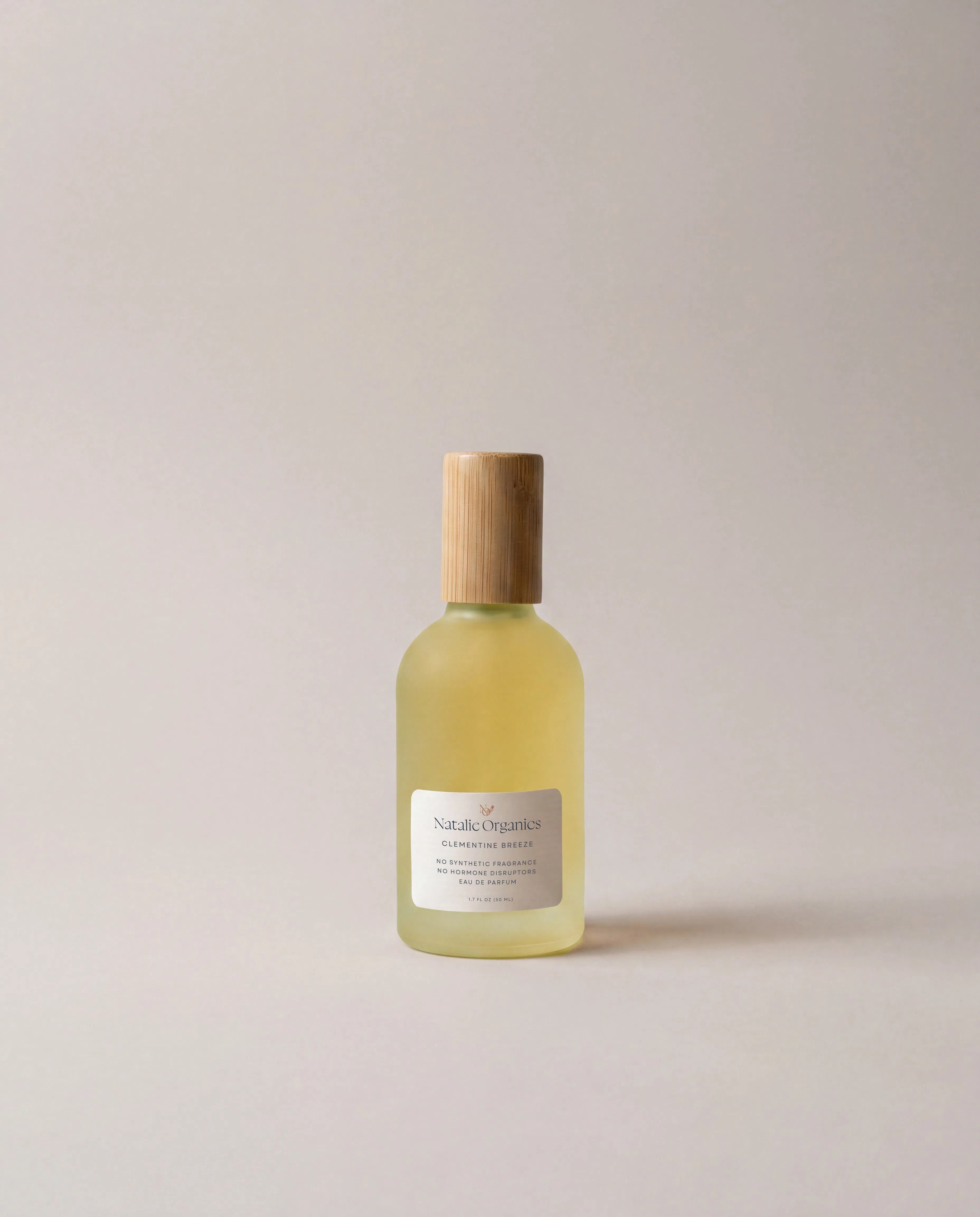 Clementine Breeze fragrance bottle with light yellow liquid, wooden cap, and front label
