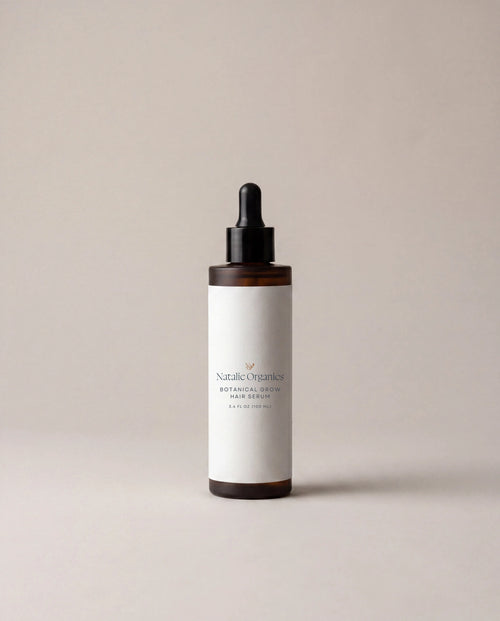 Hair serum bottle with dark amber glass and black dropper, white label