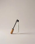 Brow and lash growth serum bottle with black applicator wand