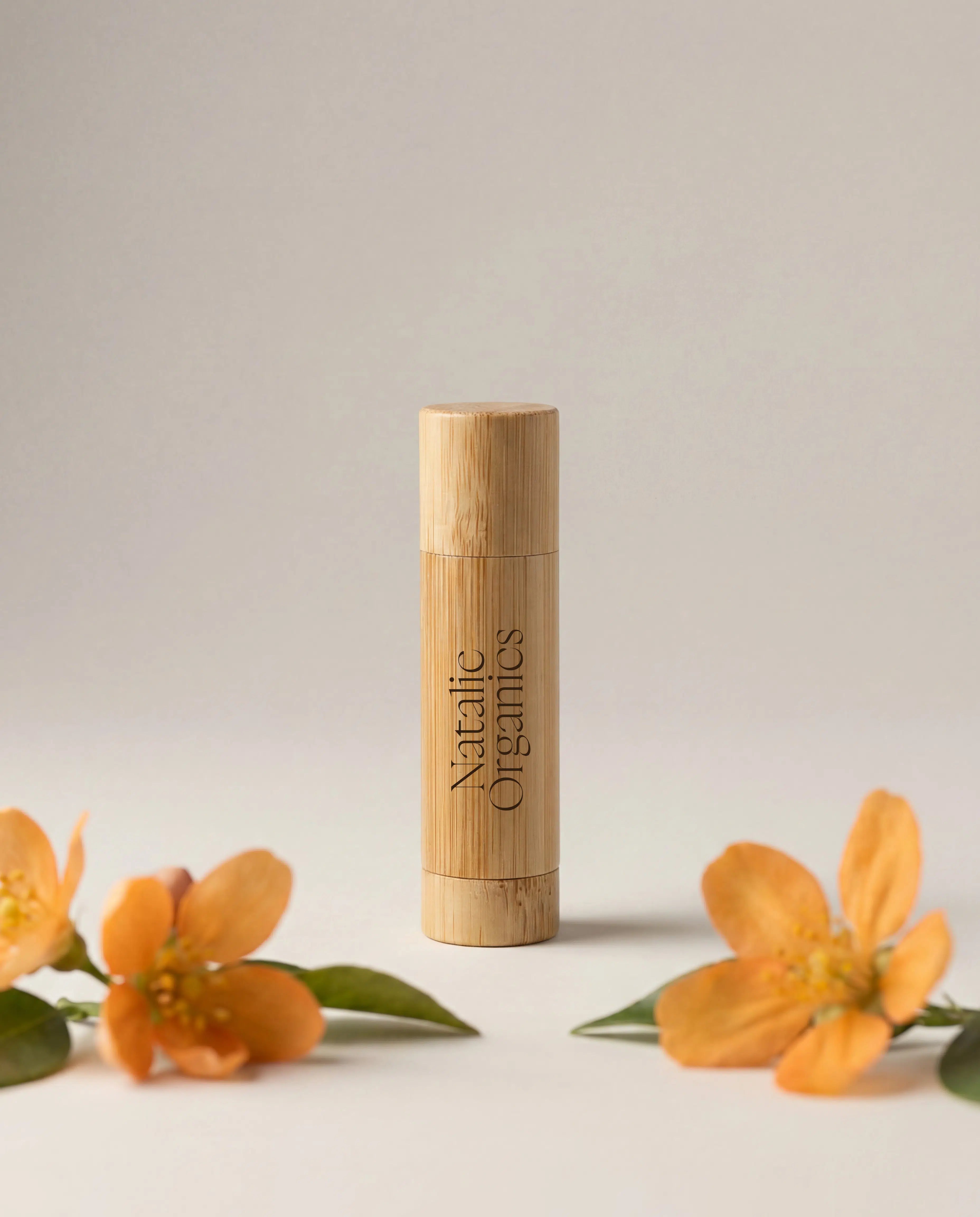 Organic lip balm in light wood cylindrical tube, vertical label