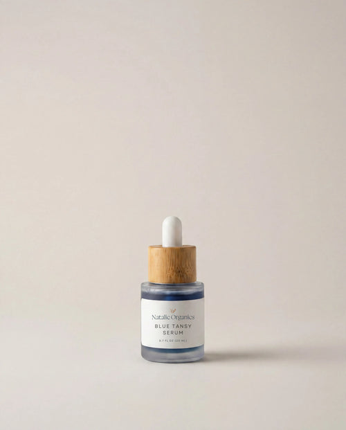 Blue tansy serum bottle with white dropper, glass vial and wood collar