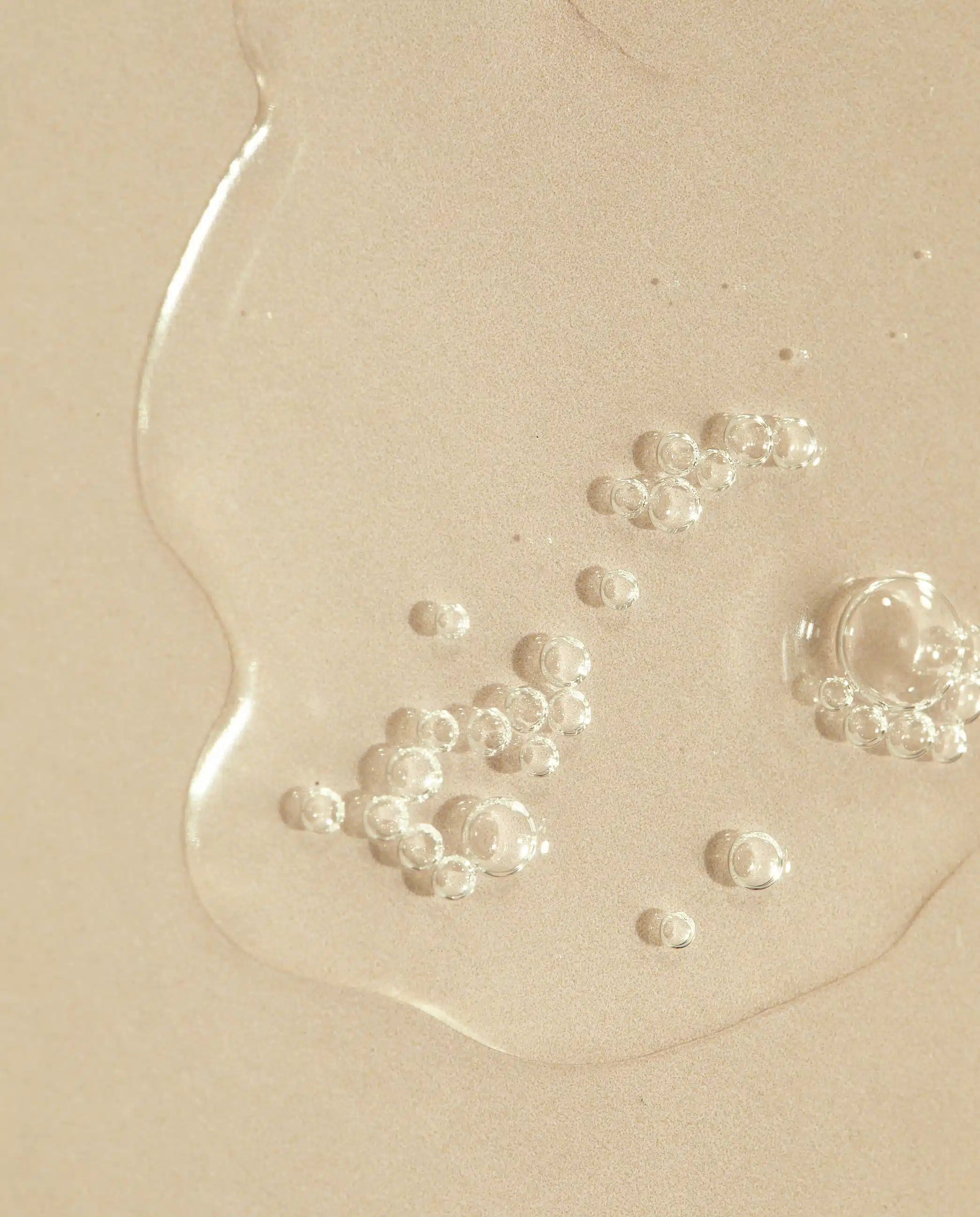 Transparent hyaluronic serum with scattered tiny bubbles on surface