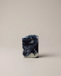 Dark blue and black swirled bar soap with marbled pattern