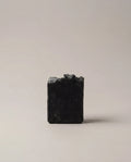 Charcoal bar soap, dark gray square block with textured surface