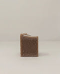 Bar soap with speckled texture, dark brown square block